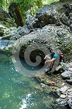 Tourist with backpack near a karstic spring
