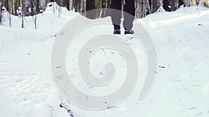 A tourist with a backpack is walking in a winter snow forest. Active recreation and hiking