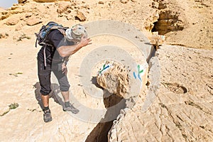 Tourist looking at desert trail markings signs.