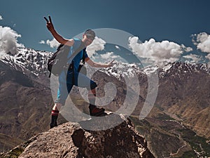 Tourist backpacker smling with Toubkal summit in the background