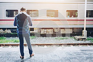 Tourist backpacker wait to travel at train station