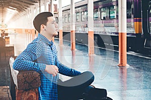 Tourist backpacker wait to travel at train station