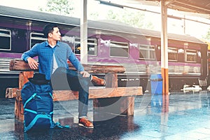 Tourist backpacker wait to travel at train station