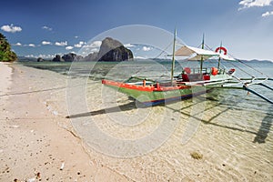 Tourist banca boat on island hopping trip. With beautiful scenery in background. Exotic nature in El Nido, Palawan