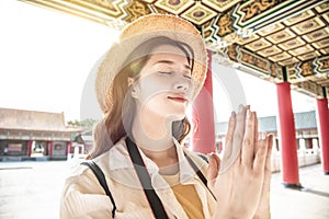 Tourist beautiful asian young woman praying at chinese temple