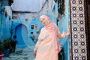 Tourist on a blue street in Chefchaouen, Morocco