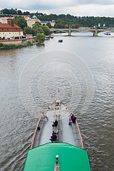 Tourist boat cruise on Vltava river in Prague.