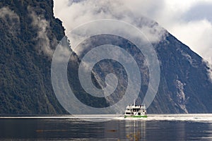 Tourist boat cruising in milford sound fjordland national park