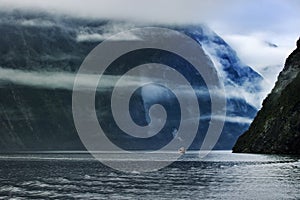 Tourist boat cruising in milford sound fjordland national park southland new zealand