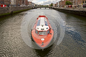 Tourist boat making its journey on the liffey river through