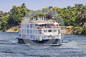 A Tourist boat motor down the River Nile towards Aswan in central Egypt. The tourist boats cruise between Luxor and Aswan in