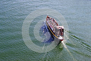 Tourist boat moving on The Duoro river in Porto