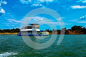 Tourist boat with traditional painting in the Guatape dam