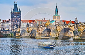 The tourist boat on Vltava River at the Charles Bridge, Prague, Czech Republic