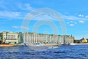 Tourist boats floating on the river Neva near the Hermitage Sunny day
