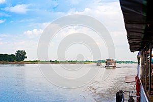 Tourist boats on the Irrawaddy river, Mandalay, Myanmar, Burma. Copy space for text.