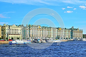 Tourist boats leave from the jetty on the Neva river near the He