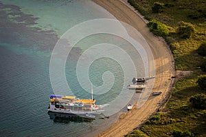 Tourist boats are parking at the empty beach.