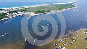 Tourist boats and speeding boats, yachts on shallow Crab Island near Santa Rosa Island beach lush green Okaloosa Island Grass photo