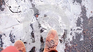 A tourist in boots runs on thin ice during a journey.