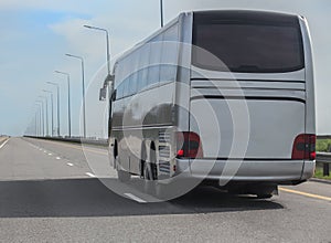 Tourist bus moves along a suburban highway
