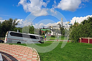 Tourist bus on the road in front of the Trinity Lavra of St.Sergius. Sergiyev Posad, Russia