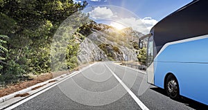 Tourist bus rushes along the country high-speed highway against the background of a mountain landscape.