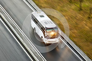 Tourist bus spee ride on highway, blured in motion. photo