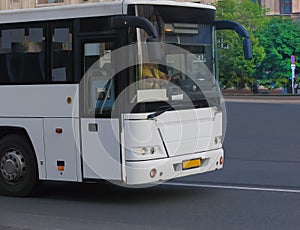 tourist bus traveling on city street