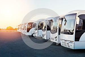Tourist buses on parking at sunrise photo