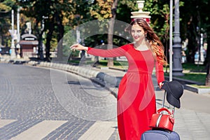 Tourist business woman is catching taxi on the city street