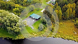 Tourist cafe near rive. Stock footage. Top view of cafe on banks of river in autumn forest. Country recreation in nature