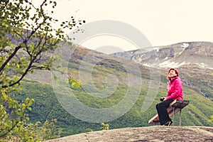 Tourist with camera looking at scenic view in mountains Norway