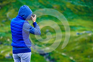 Tourist with camera and in Norway mountains