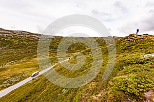 Tourist with camera in Norway mountains