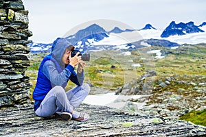 Tourist with camera in Norway mountains