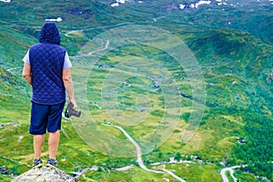 Tourist with camera and in Norway mountains