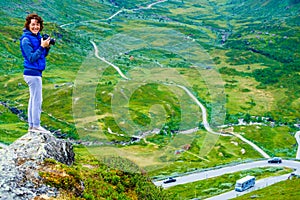 Tourist with camera and in Norway mountains