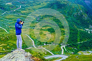 Tourist with camera and in Norway mountains