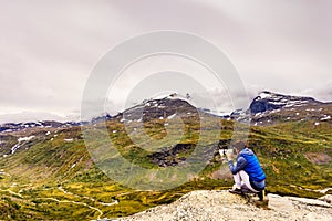 Tourist with camera in Norway mountains