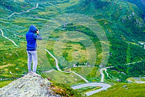 Tourist with camera and in Norway mountains