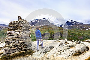 Tourist with camera in Norway mountains