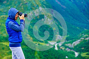 Tourist with camera and in Norway mountains