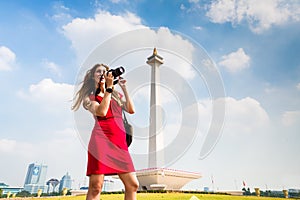 Tourist with camera sightseeing at Monumen Nasional