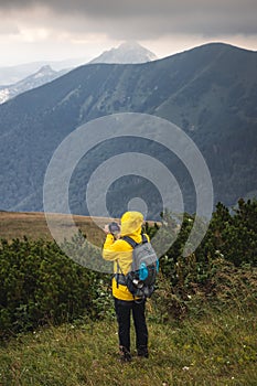 Tourist with camera taking picture of landscape