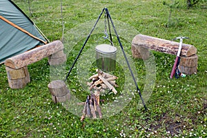 Tourist camp, tent, firewood and a pot