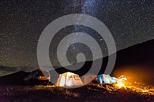 Tourist camping at sea coast at night