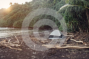 Tourist camping tent on wild ocean beach on tropical island