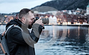 Tourist with camrea against Tyskebryggen in Bergen, Norway