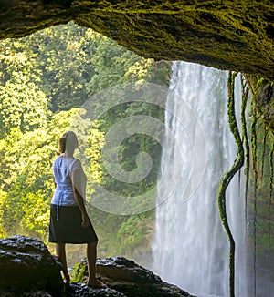 Tourist In Cave At Misol Ha Waterfall photo